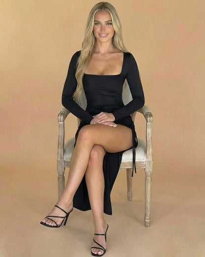 Nocturne Midi Dress by Lauven, featuring a square neck and slit, worn by a model seated elegantly.