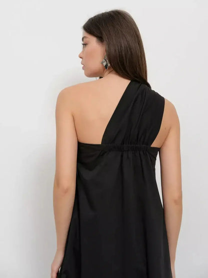 Noir Fold Maxi Dress featuring a one-shoulder design and elegant draping from the back view.