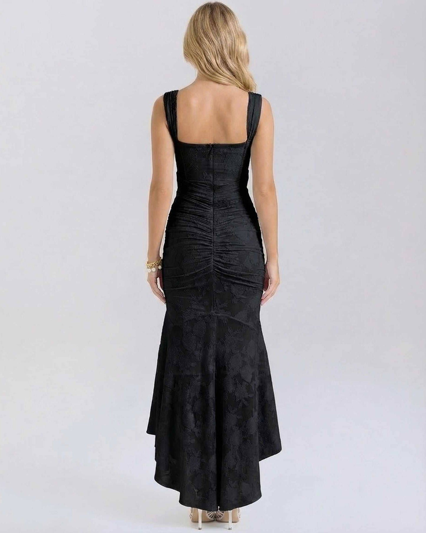Noir Maxi Dress by Lauven showing back view with pleated details and fish tail hem in black.
