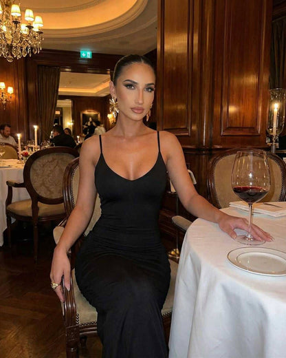 Lauven Noir Maxi Dress on a model in a sophisticated restaurant setting, featuring sleeveless design and elegant black tone.