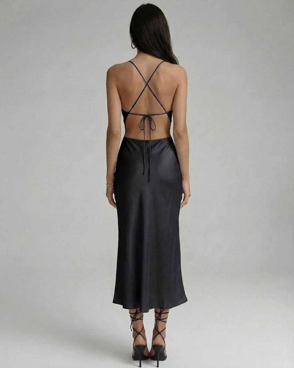 Noir Midi Dress back view showcasing sleek black design, sling straps, and flattering silhouette by Lauven.