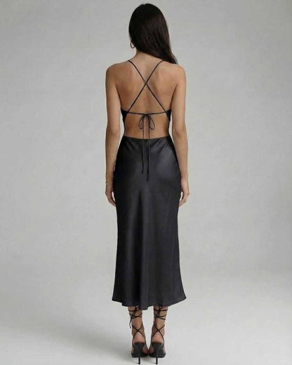 Noir Midi Dress back view showcasing sleek black design, sling straps, and flattering silhouette by Lauven.