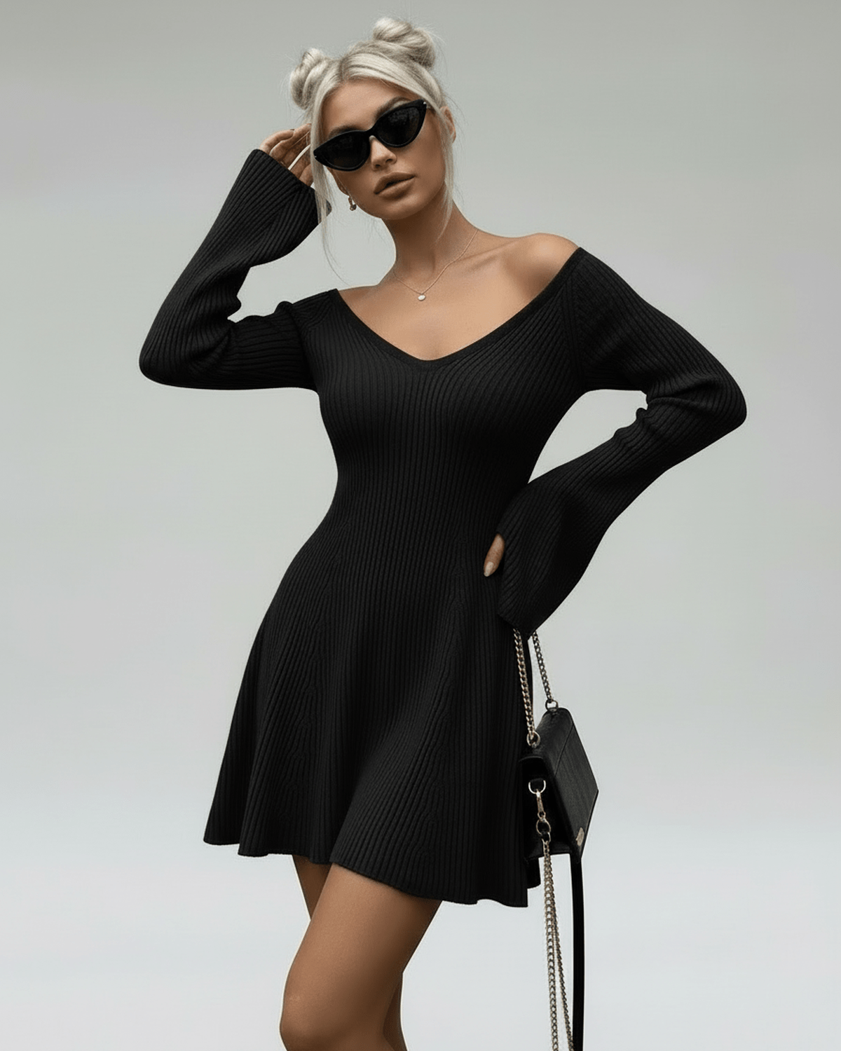 Model showcasing the Lauven Noir Mini Dress, a slim fit black knit with V-neck and flared sleeves.