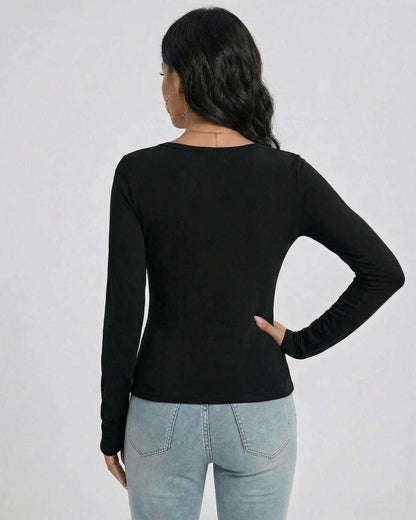 Back view of a woman wearing the Noir Pullover from Lauven, featuring a slim fit and long sleeves.