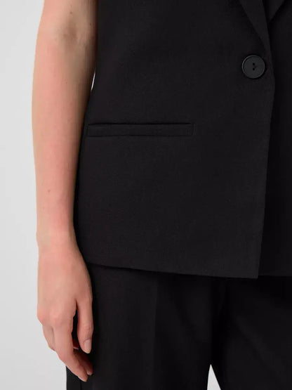 Noir Suit Set by Lauven featuring a close-up of a tailored sleeveless black vest pocket.