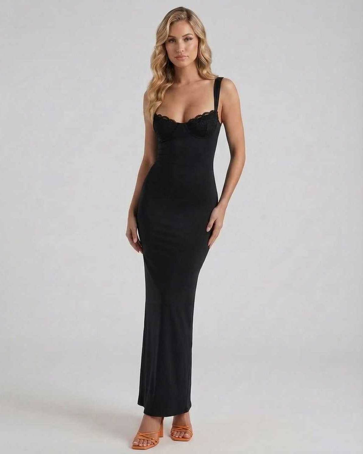 Model wearing the Noiré Maxi Dress by Lauven, showcasing sleek black satin elegance in a streamlined silhouette.