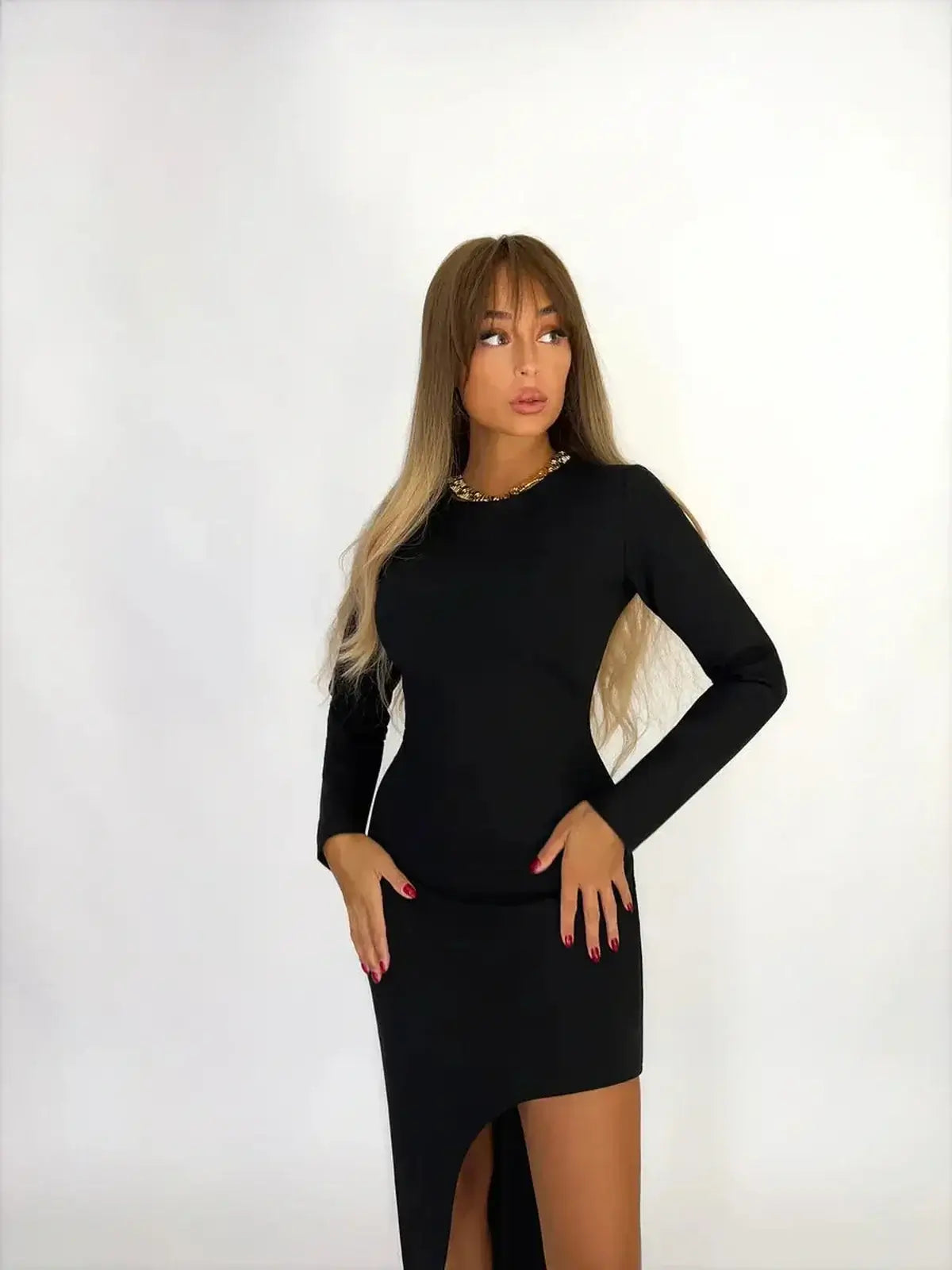 Model showcasing the Noirline Maxi Dress, a sleek black gown with a sculptural silhouette and asymmetric hem.