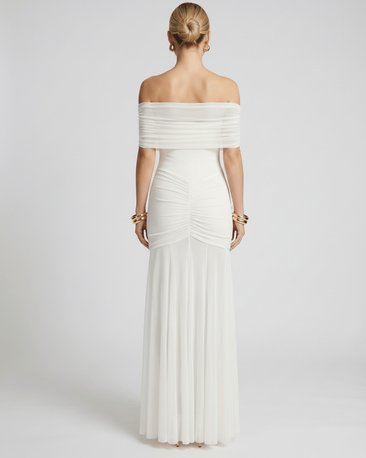 Elegant back view of the Noirline Maxi Dress, an off-shoulder maxi dress by Lauven, featuring ruched detailing and a flowing sheer skirt.
