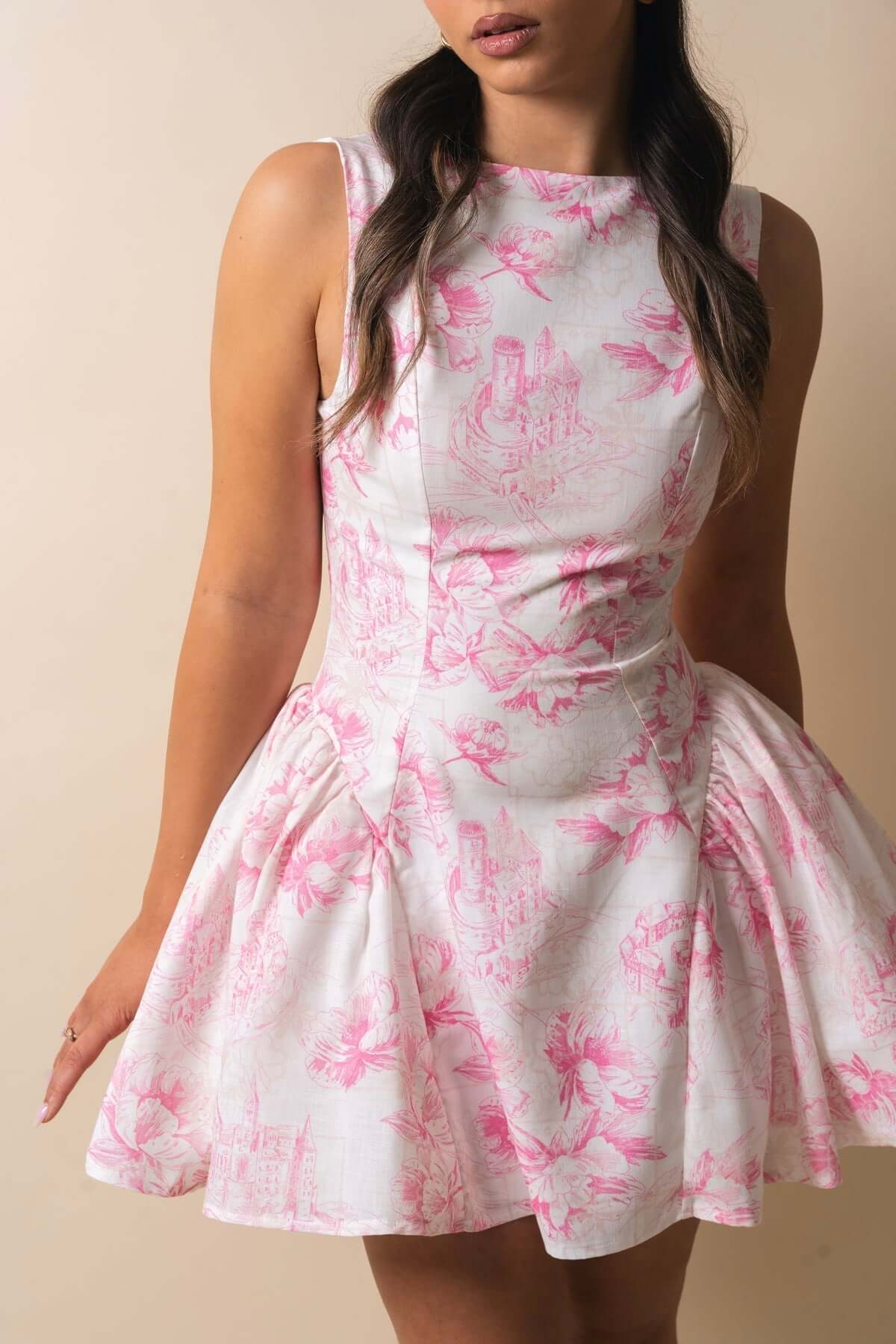 Nora Mini Dress featuring a floral design in soft pink on a white fabric, perfect for summer events and formal occasions.