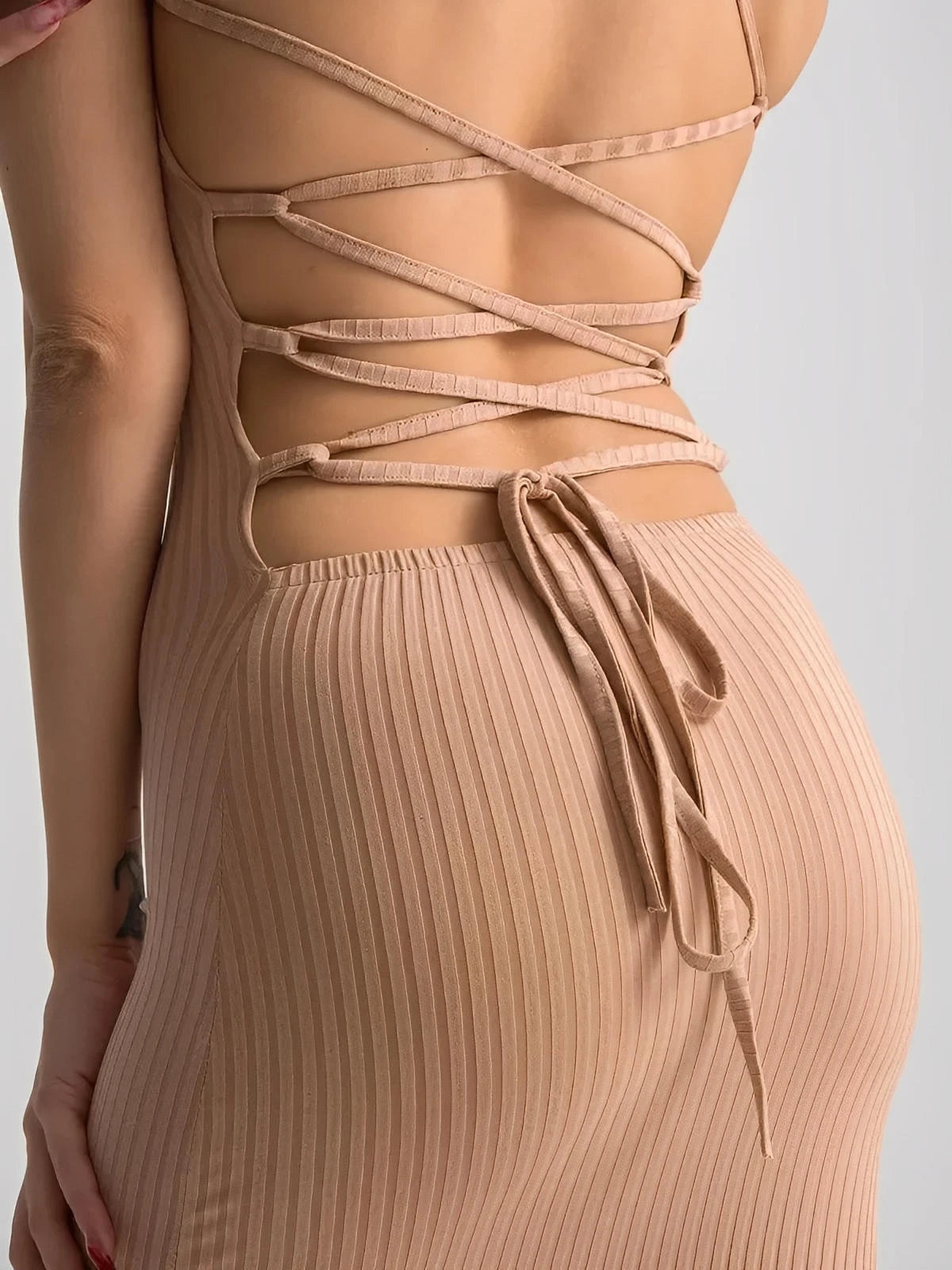 Close-up of the back of a Nude Lace Midi Dress highlighting its corset lace-up design and ribbed fit.