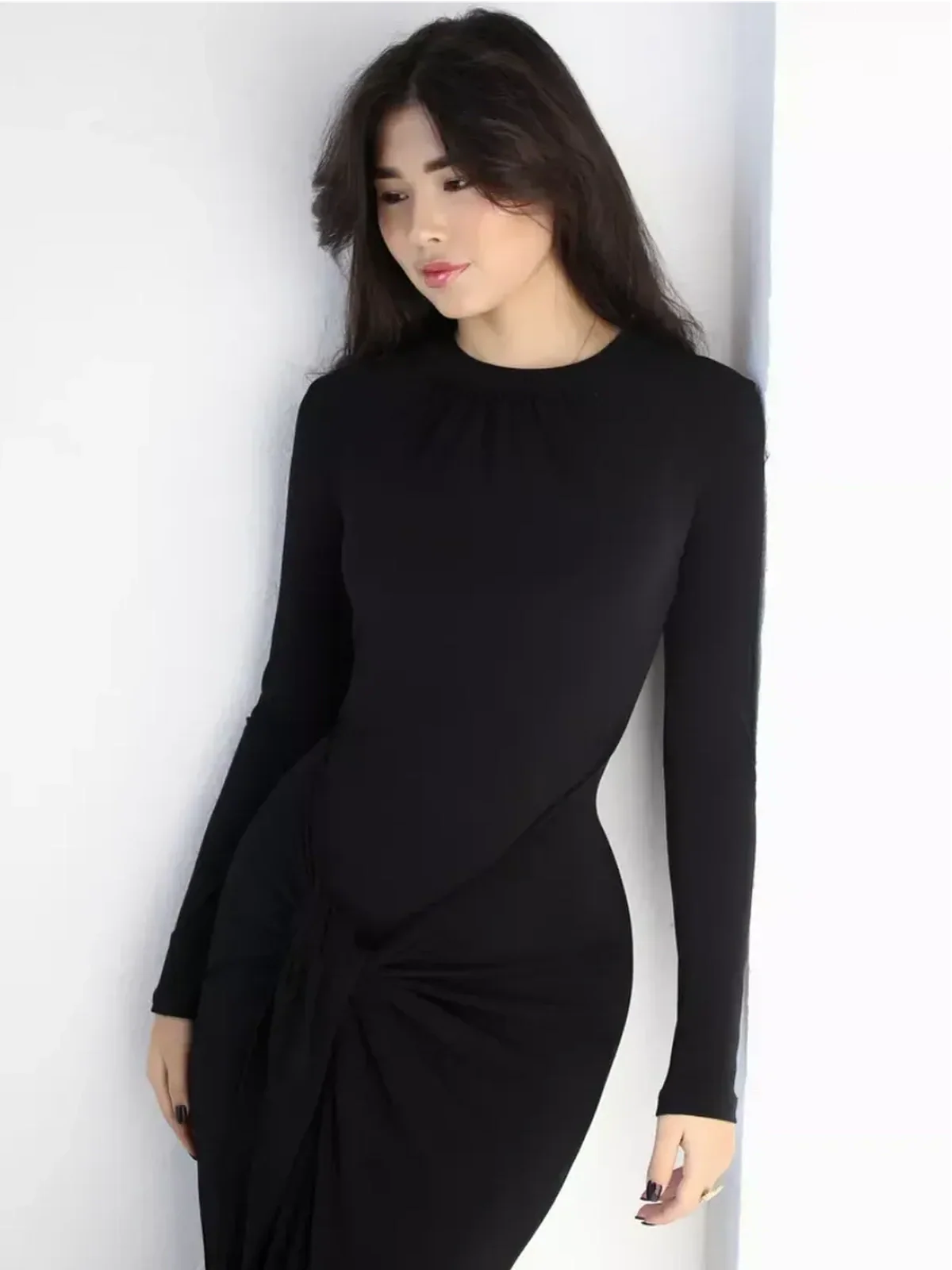 Model wearing an Obsidian Drape Maxi Dress with a high neckline and flattering knot detail.