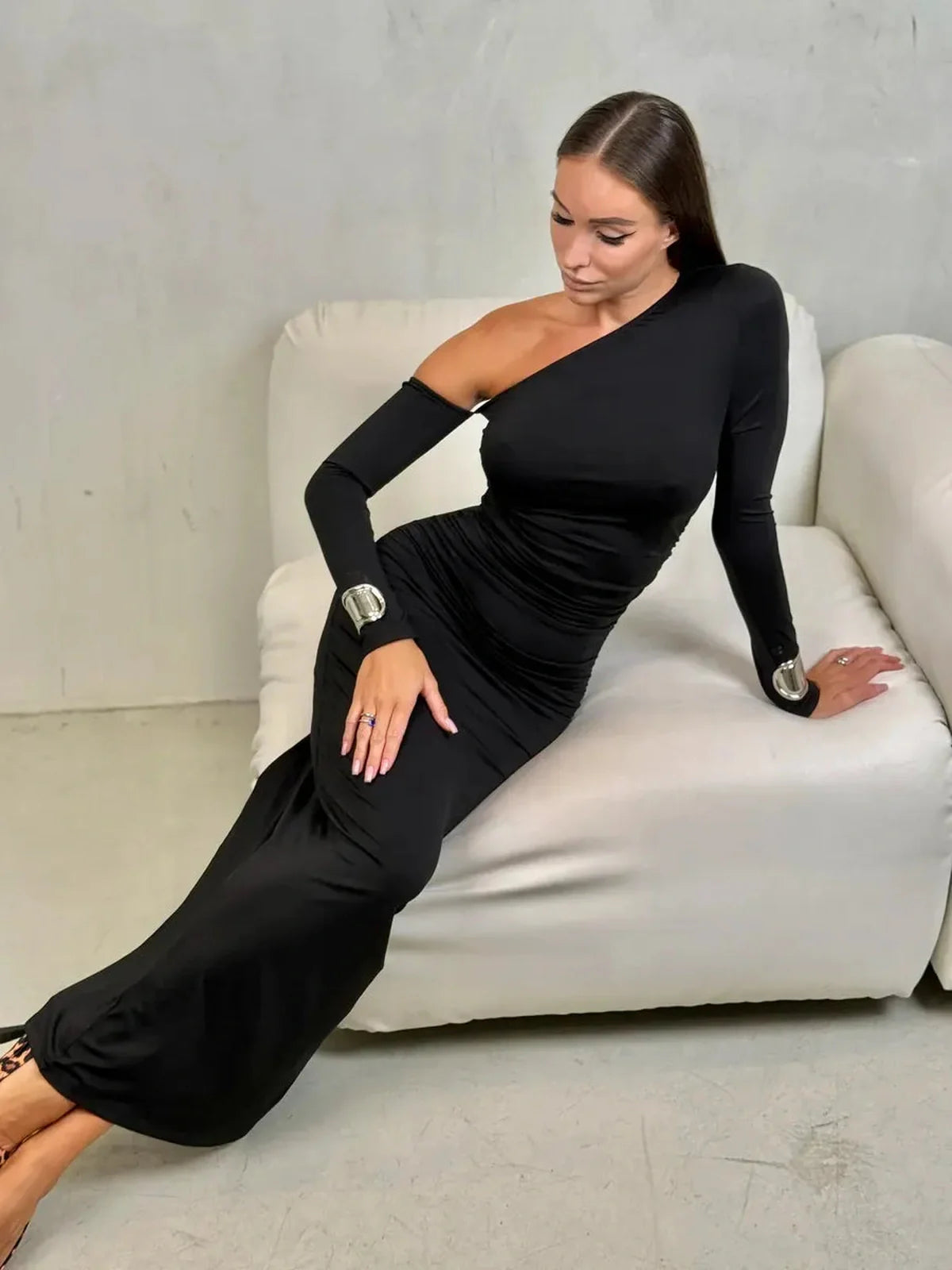 Model wearing the Obsidian Maxi Dress with asymmetric neckline, showcasing sleek draping and elegant silhouette.