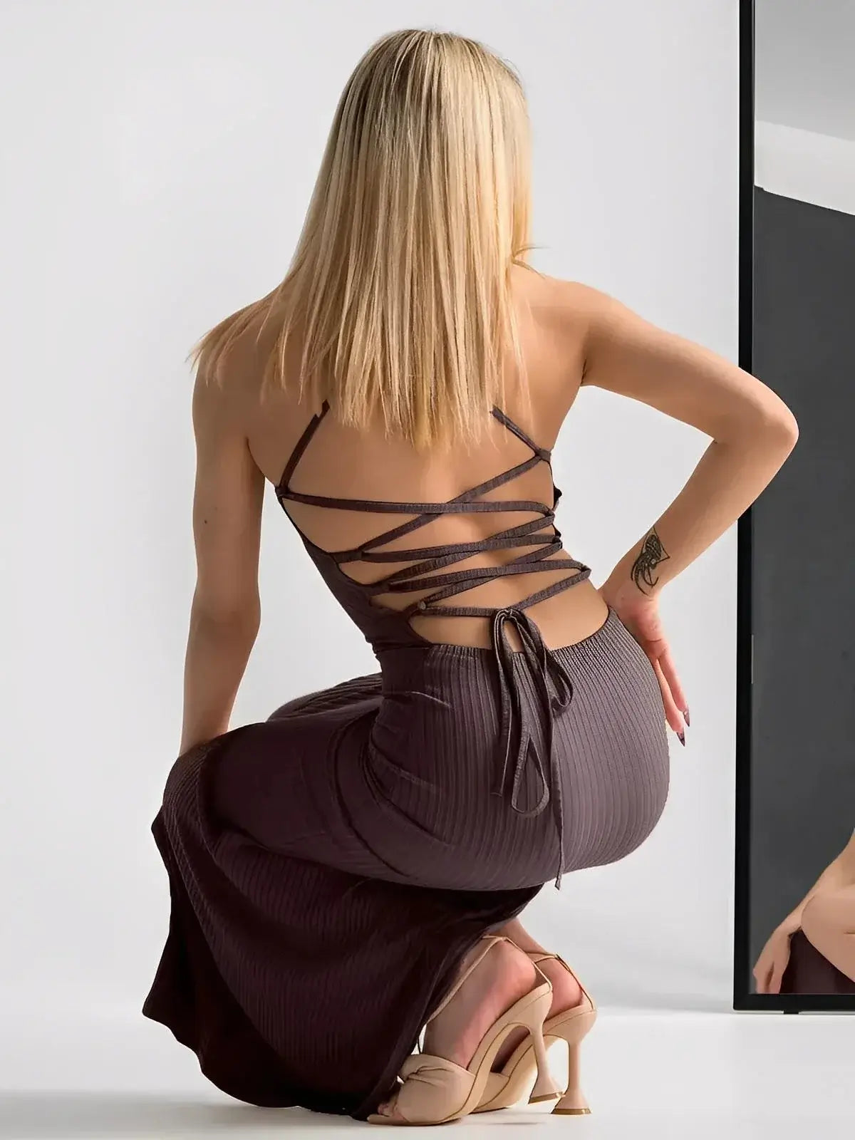 Lauven Obsidian Midi Dress with strappy back, showcasing sculpted fit and elegant thigh-high slit.