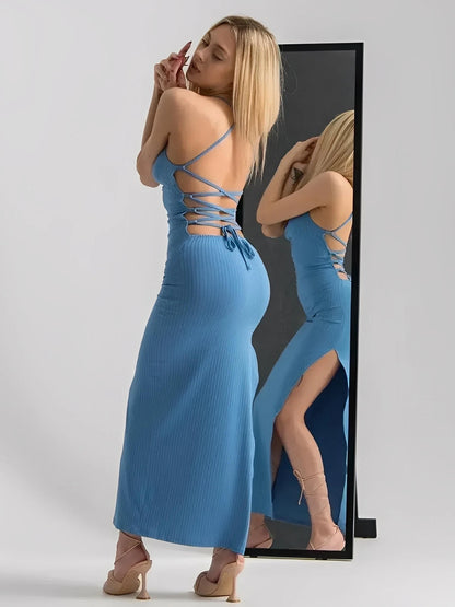 Model in Ocean Lace Midi Dress showcasing ribbed fabric and lace-up back with side slit, reflecting summer tones.
