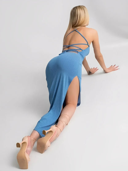 Woman in Ocean Lace Midi Dress showcasing ribbed knit, corset back, and bold side slit, ideal for summer elegance.