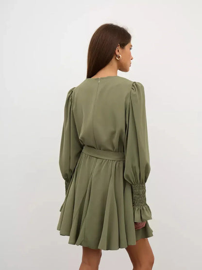 Olive Luxe Mini Dress showcasing back view with long sleeves, ruffle details, and a waist-cinching belt in olive green.