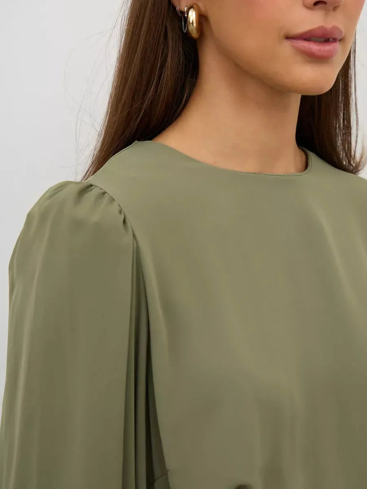 Close-up of the Olive Luxe Mini Dress showcasing its refined olive green fabric and elegant round neckline.