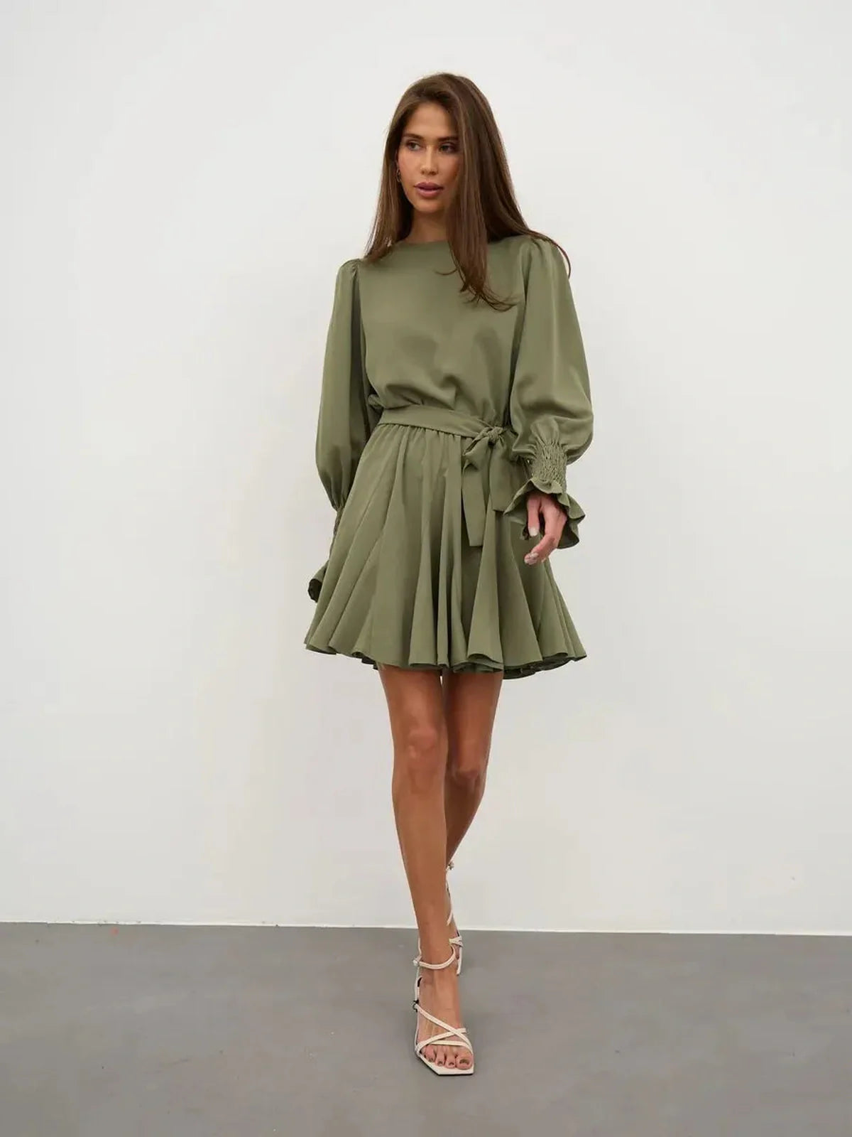 Olive Luxe Mini Dress featuring a refined silhouette, long sleeves, and ruffle details in sophisticated olive green.