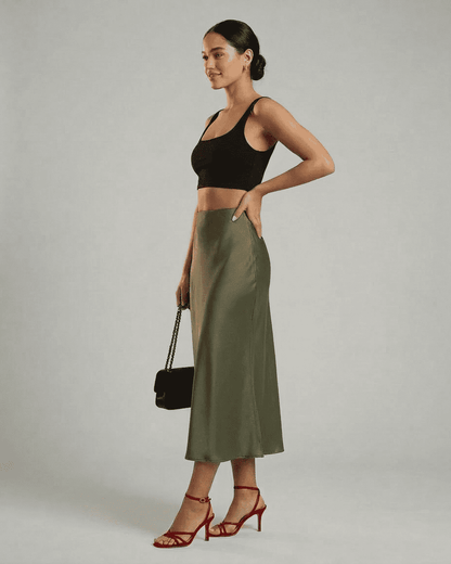 Model displaying the Olivia Midi Skirt by Lauven, featuring a satin mermaid silhouette in olive green.