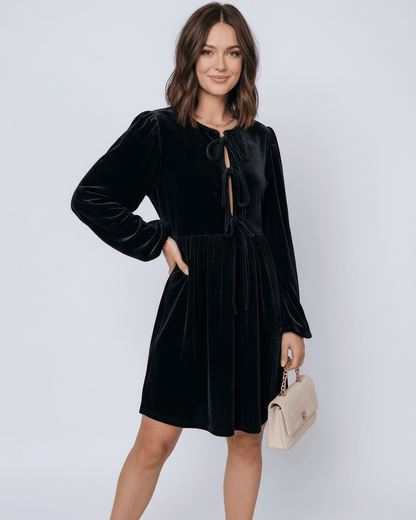 Onyx Mini Dress by Lauven, featuring a sleek black velvet design with drawstring detail and long lantern sleeves.