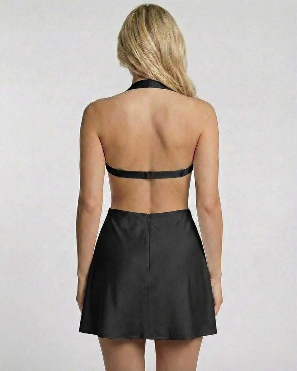 Back view of a woman wearing the Onyx Mini Dress by Lauven, showcasing its sleek black satin fabric and halter neck design.