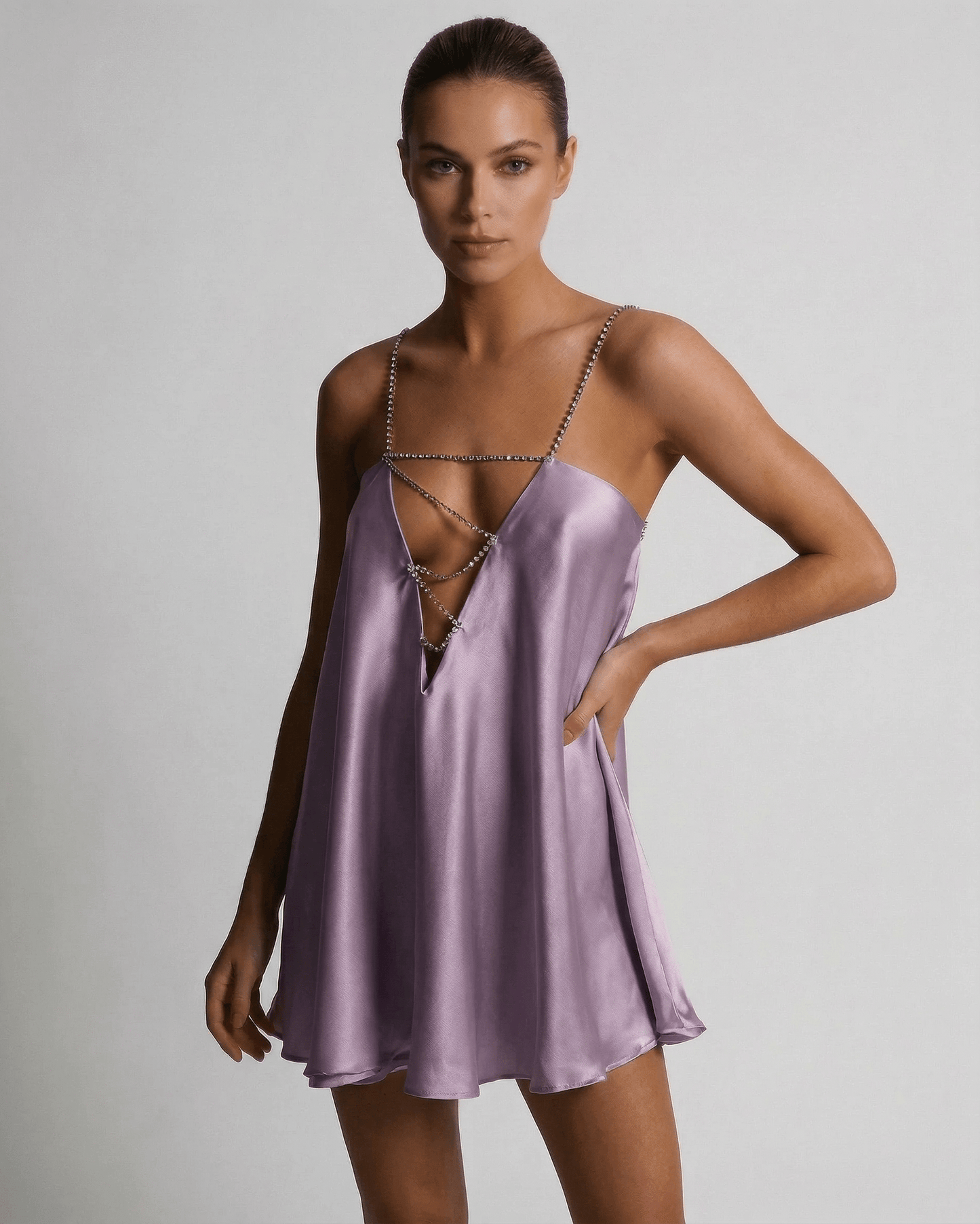 Model wearing the Lyra Mini Dress by Lauven, a luxurious lilac satin A-line dress with rhinestone detail.