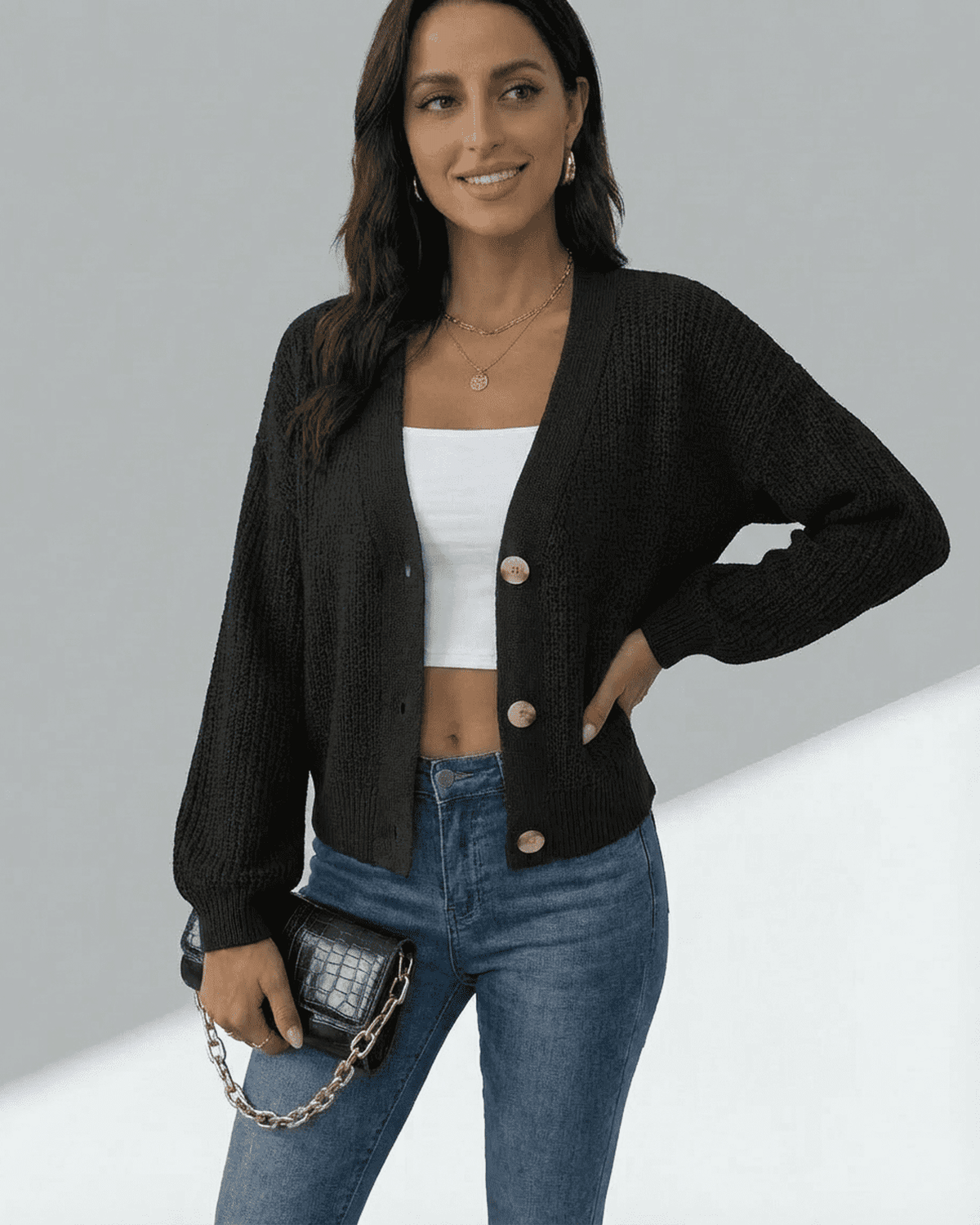 Model wearing Lauven Orion Cardigan in black, showcasing long sleeves and button front design over a white top.