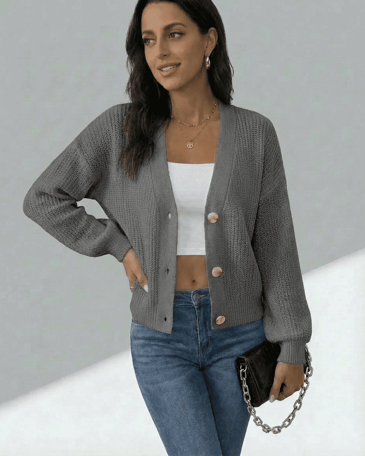 Orion Cardigan by Lauven, a textured knit button-front cardigan in gray, styled with a casual top and jeans.