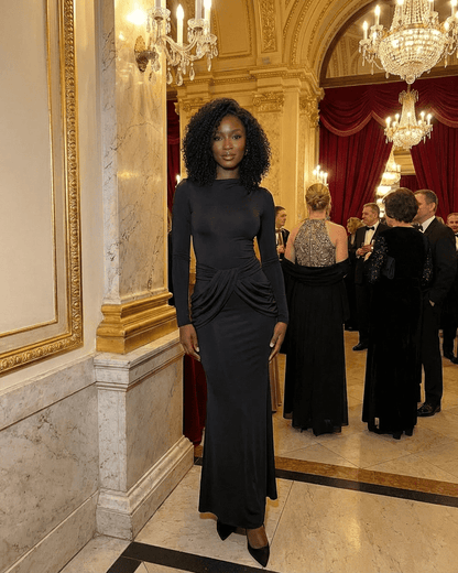 Orion Maxi Dress by Lauven, showcasing long sleeve crew neck silhouette with ruched high waist detail in elegant setting.