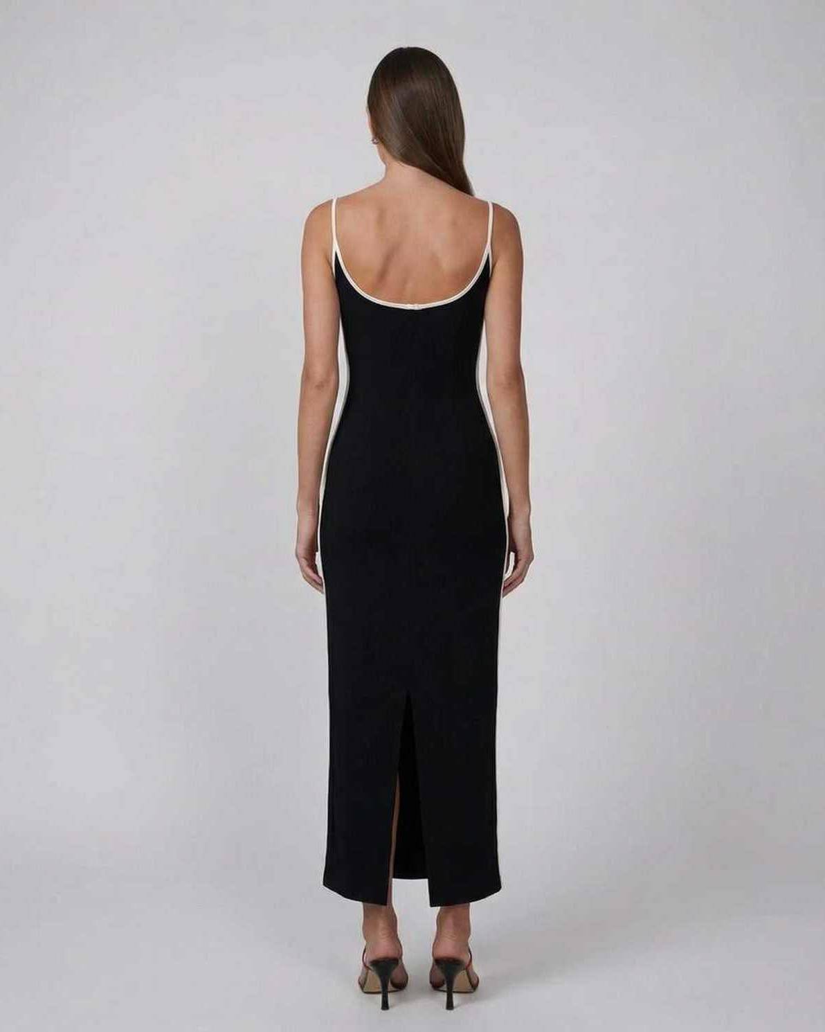 Orion Midi Dress by Lauven - Back view of sleek black slim fit dress with contrast piping and side slit.