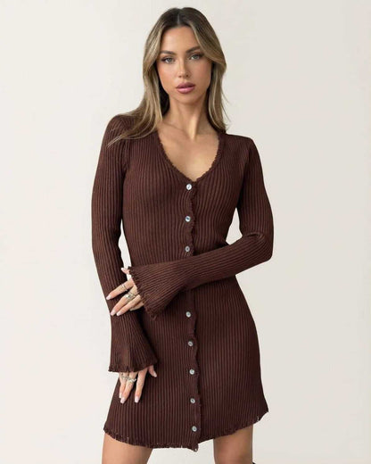 Model wearing the Orion Mini Dress by Lauven, a ribbed bodycon mini dress with flare sleeves and button details in deep chocolate brown.