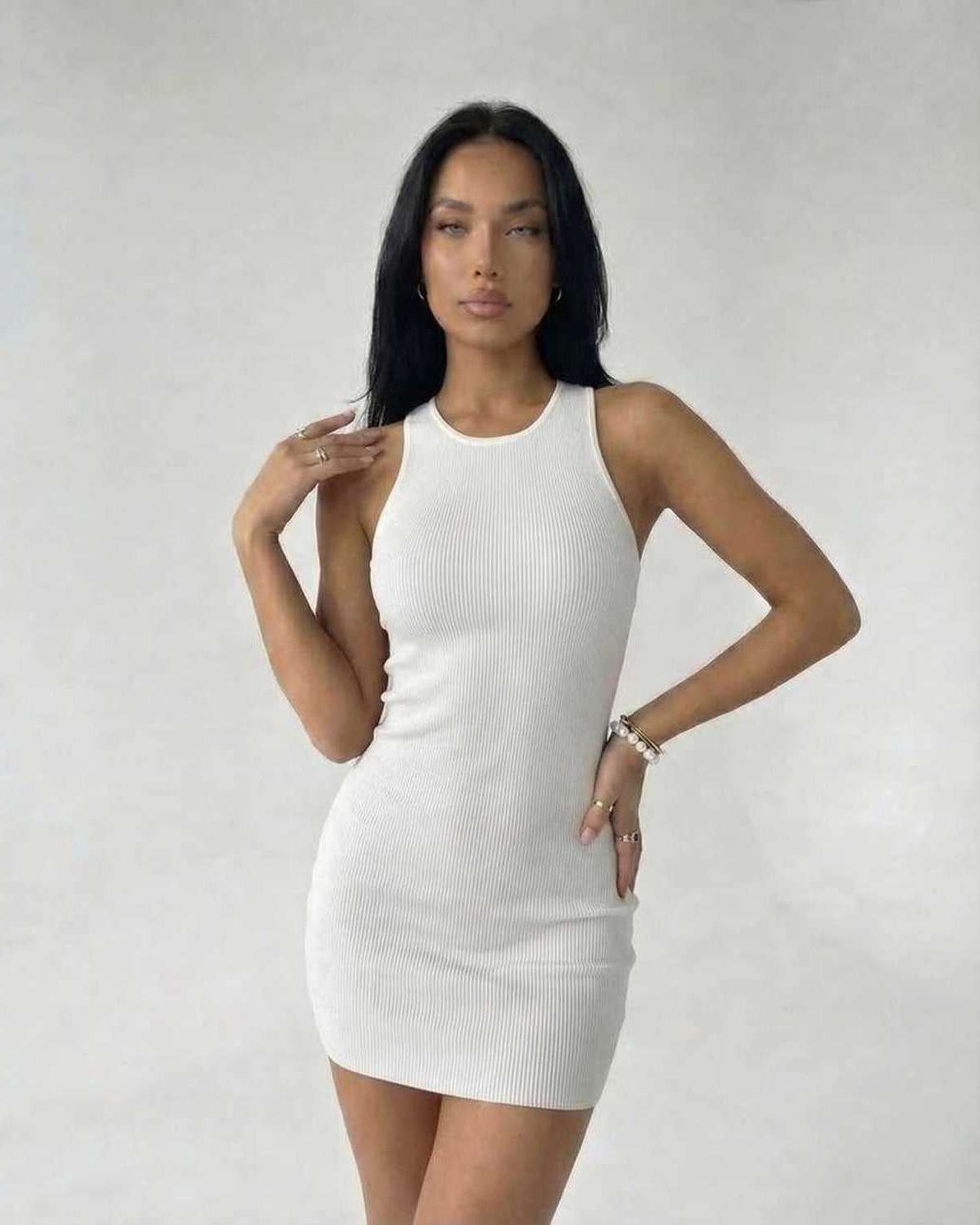 Orion Mini Dress by Lauven – Ribbed knit white mini dress with cross-back detail, showcasing a sleek silhouette.