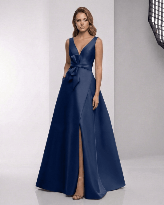 Orlena Maxi Dress – Navy satin A-line dress with wrap slit, bow detail, and plunging V-neckline by Lauven.