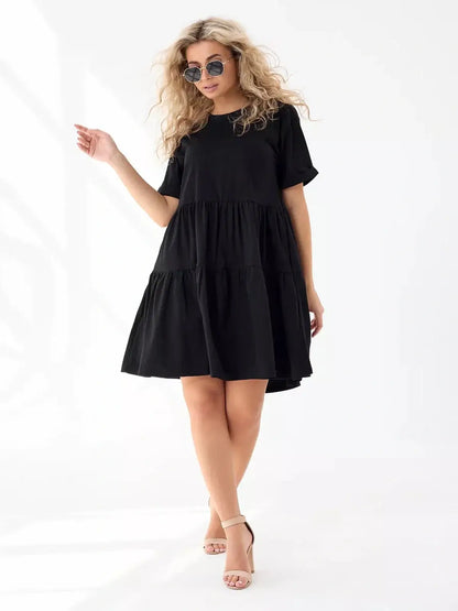 Oversized black mini dress with tiered silhouette, perfect for summer days and stylish casual wear.