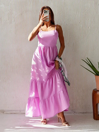 Petal Drift Maxi Dress in pink, featuring voluminous ruffles and an open back for a romantic summer look.