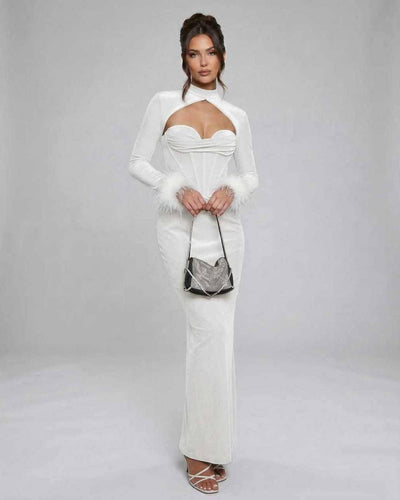 Elegant model wearing Solstice Maxi Dress by Lauven, featuring white velvet and feathered sleeves for a chic look.