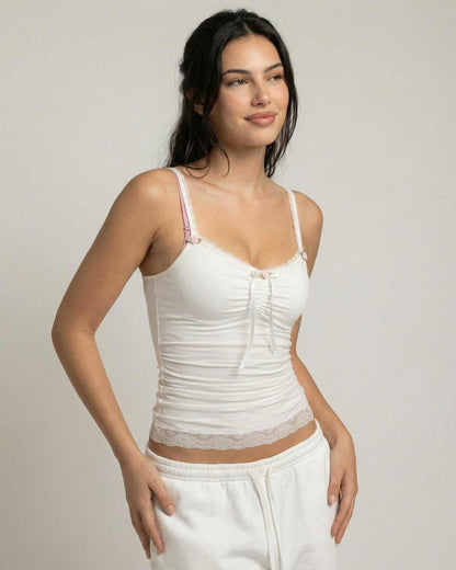 Model wearing the Lunelle Top by Lauven, a soft ivory lace trim camisole with bow detail and comfortable fit.