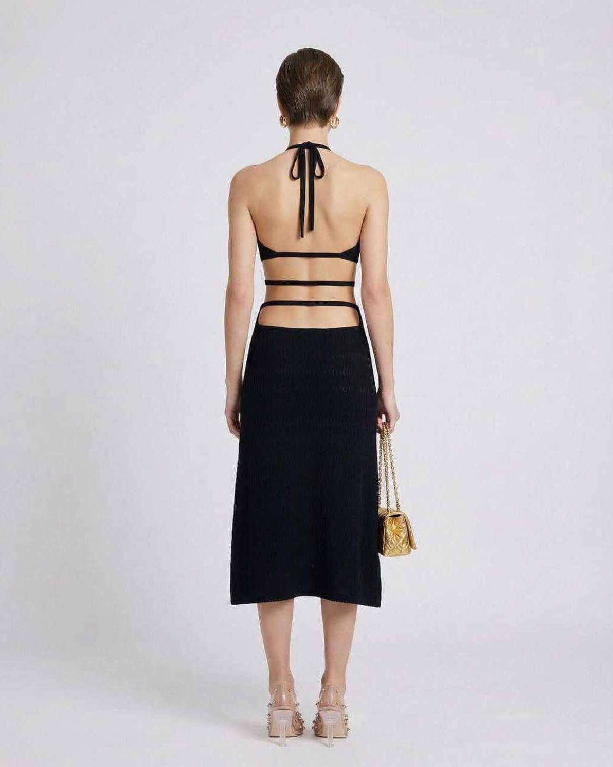Nova Midi Dress by Lauven – Back view of a sleek black knit dress with sexy A-line silhouette and adjustable straps.
