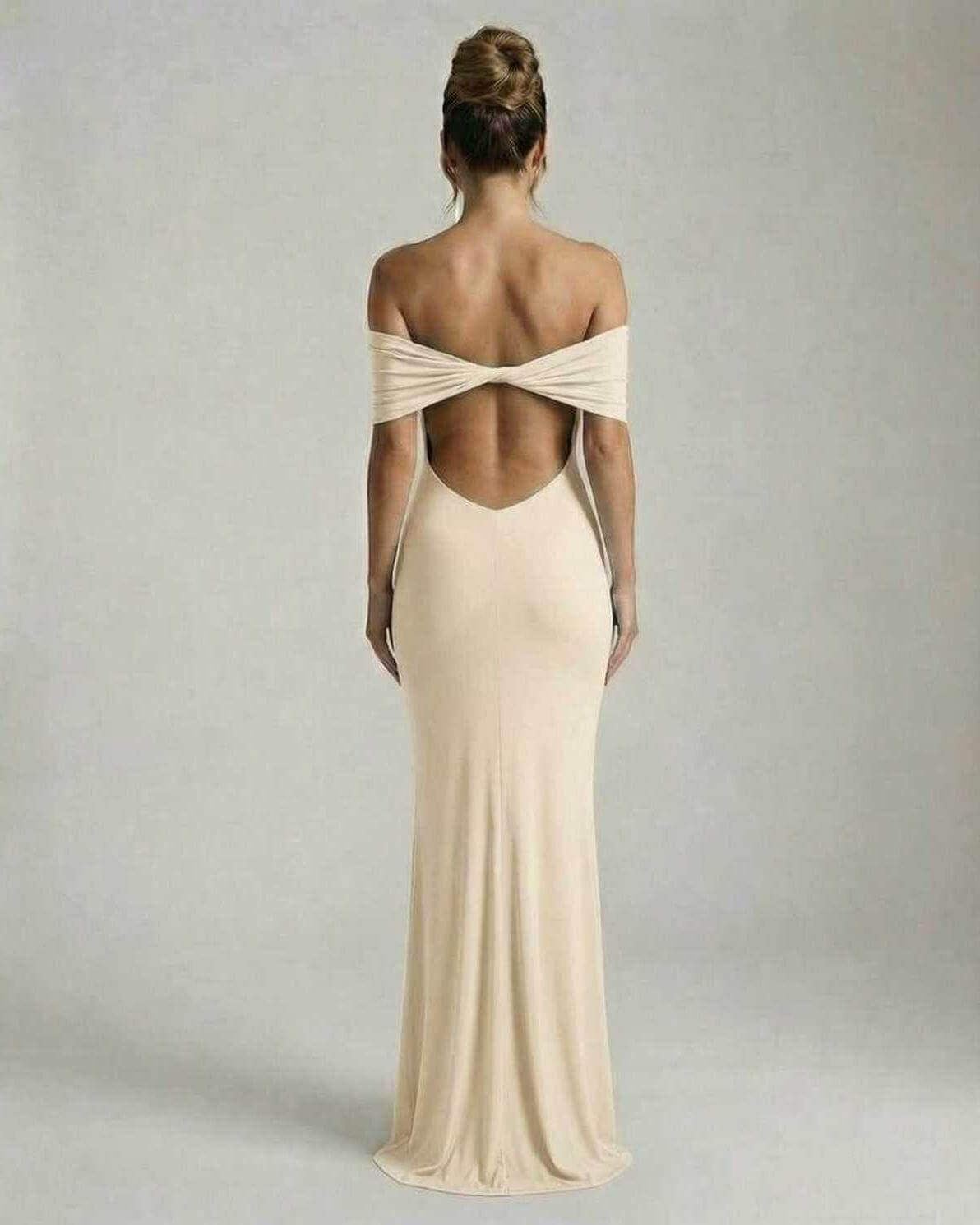 Back view of a woman wearing the Lauven Soleil Maxi Dress in soft nude with an off-shoulder neckline and backless design.
