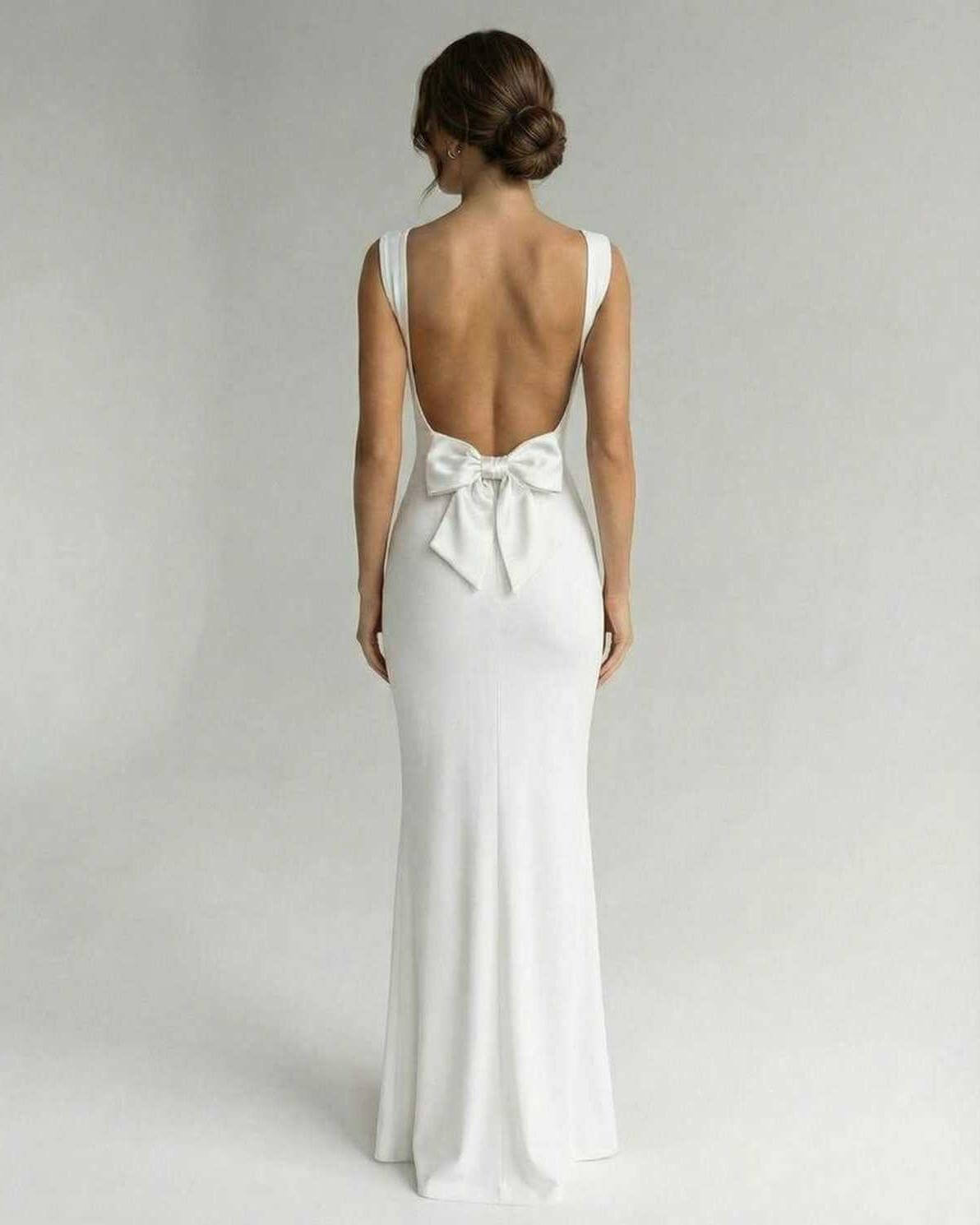 Velora Maxi Dress by Lauven - Elegant back view with bow detail in classic white, showing strappy open back and sleek silhouette.