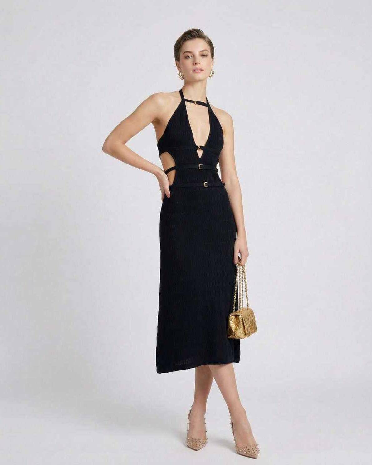 Model wearing Lauven Nova Midi Dress, a sleek black dress with a V-neckline and A-line silhouette.