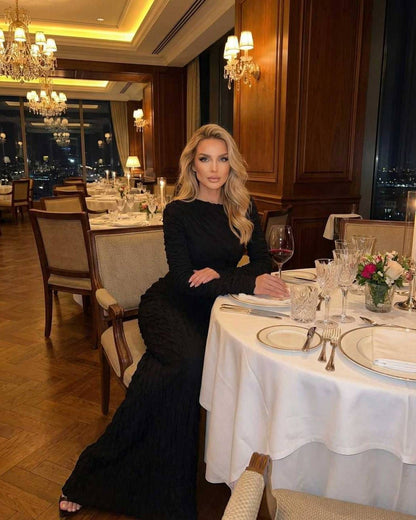 Noir Maxi Dress by Lauven worn at an elegant dinner setting with stylish decor.
