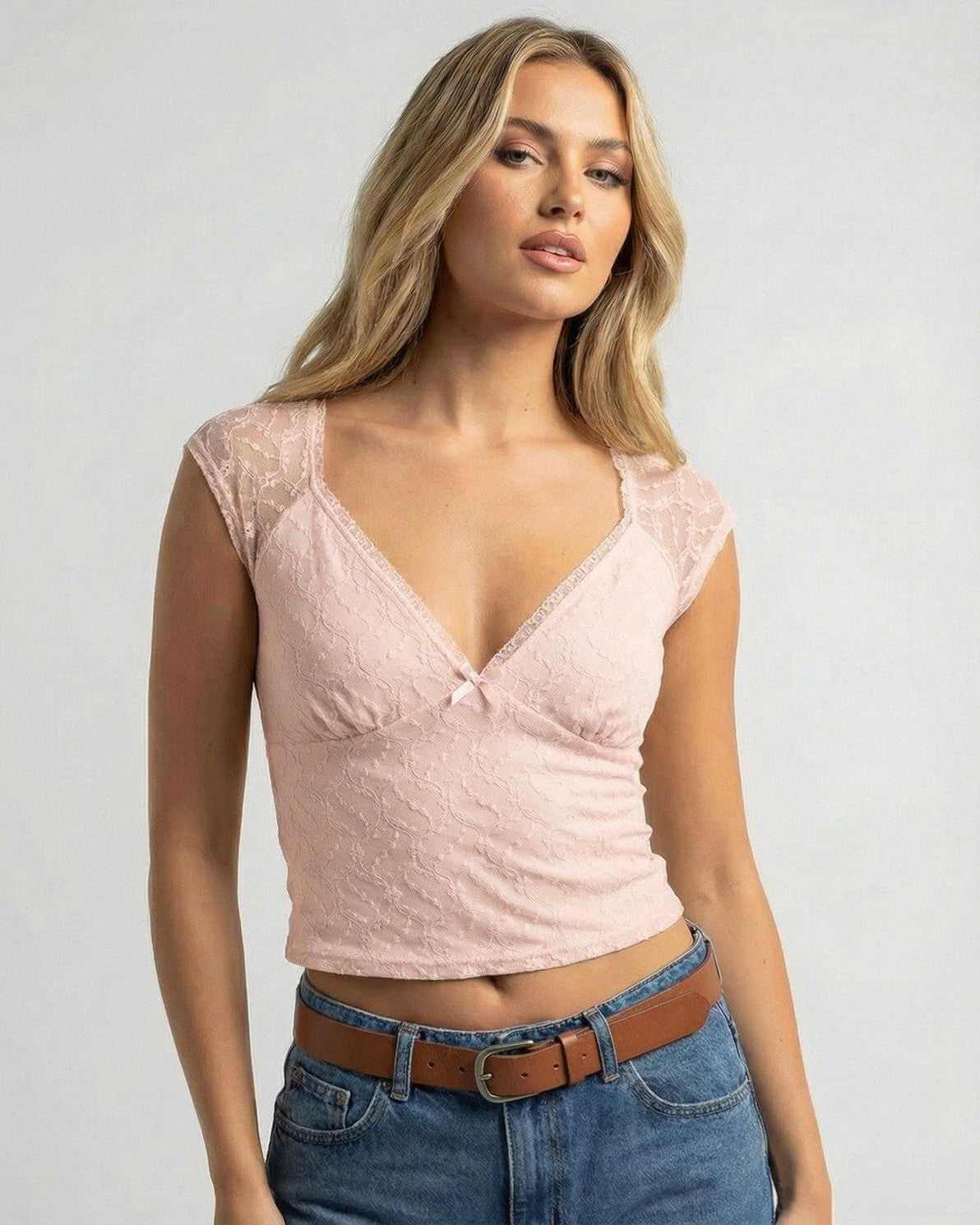 Pink Lace Top by Lauven, a soft slim-fit V-neck crop tee in blush pink with lace detail and small bow.