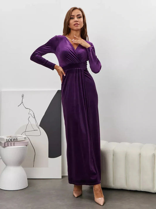 Model wearing a Plum Aura Maxi Dress in rich velvet with long sleeves and a draped silhouette.