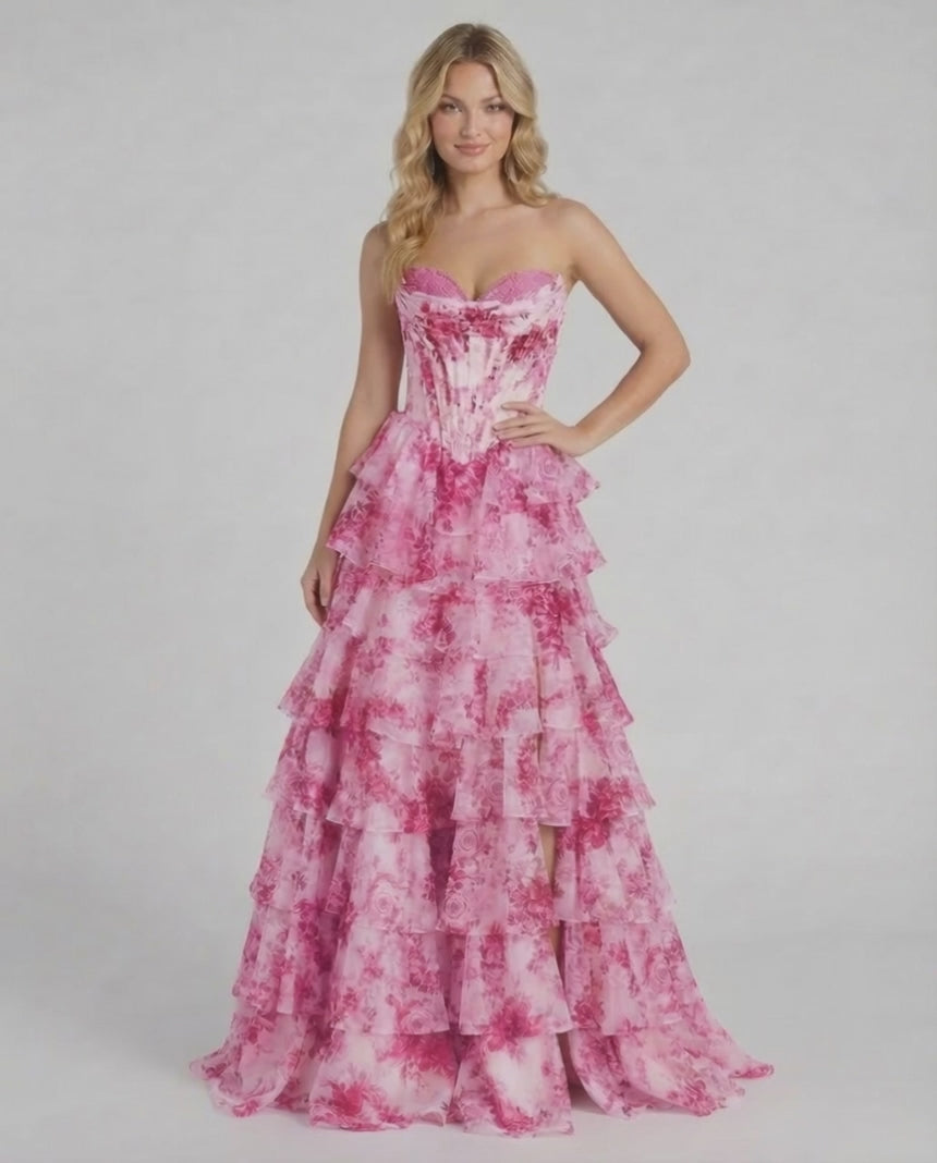 Rosalia Maxi Dress by Lauven features a pink floral chiffon gown with tiered ruffles and a corset bodice.