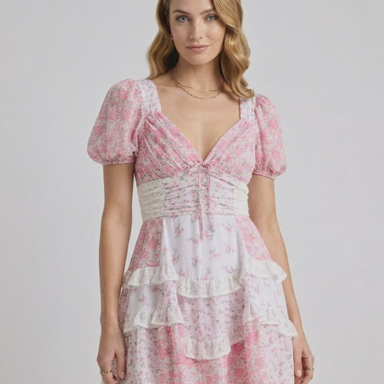 Blossom Mini Dress featuring romantic floral print, tiered ruffles, and A-line silhouette by Lauven.