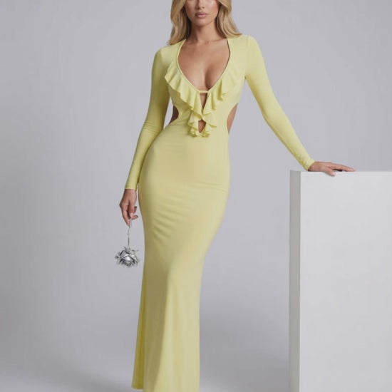 Zahara Maxi Dress in yellow with ruffle V-neck and open back, showcasing bodycon fit and elegant design by Lauven.