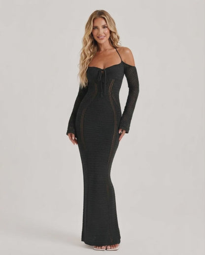 Model wearing Noir Maxi Dress, a black long sleeve bodycon gown with open back halter design by Lauven, showcasing elegant style.