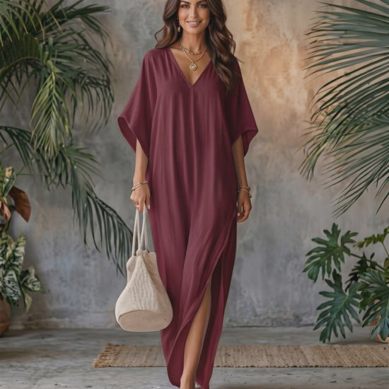 Beautiful woman wearing Solara Maxi Dress in burgundy, lightweight chiffon with V-neck and relaxed silhouette, by Lauven.