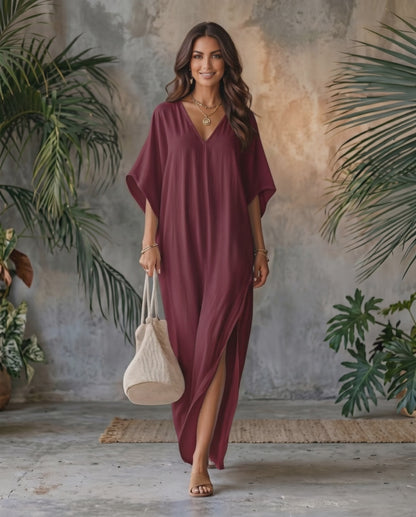 Beautiful woman wearing Solara Maxi Dress in burgundy, lightweight chiffon with V-neck and relaxed silhouette, by Lauven.